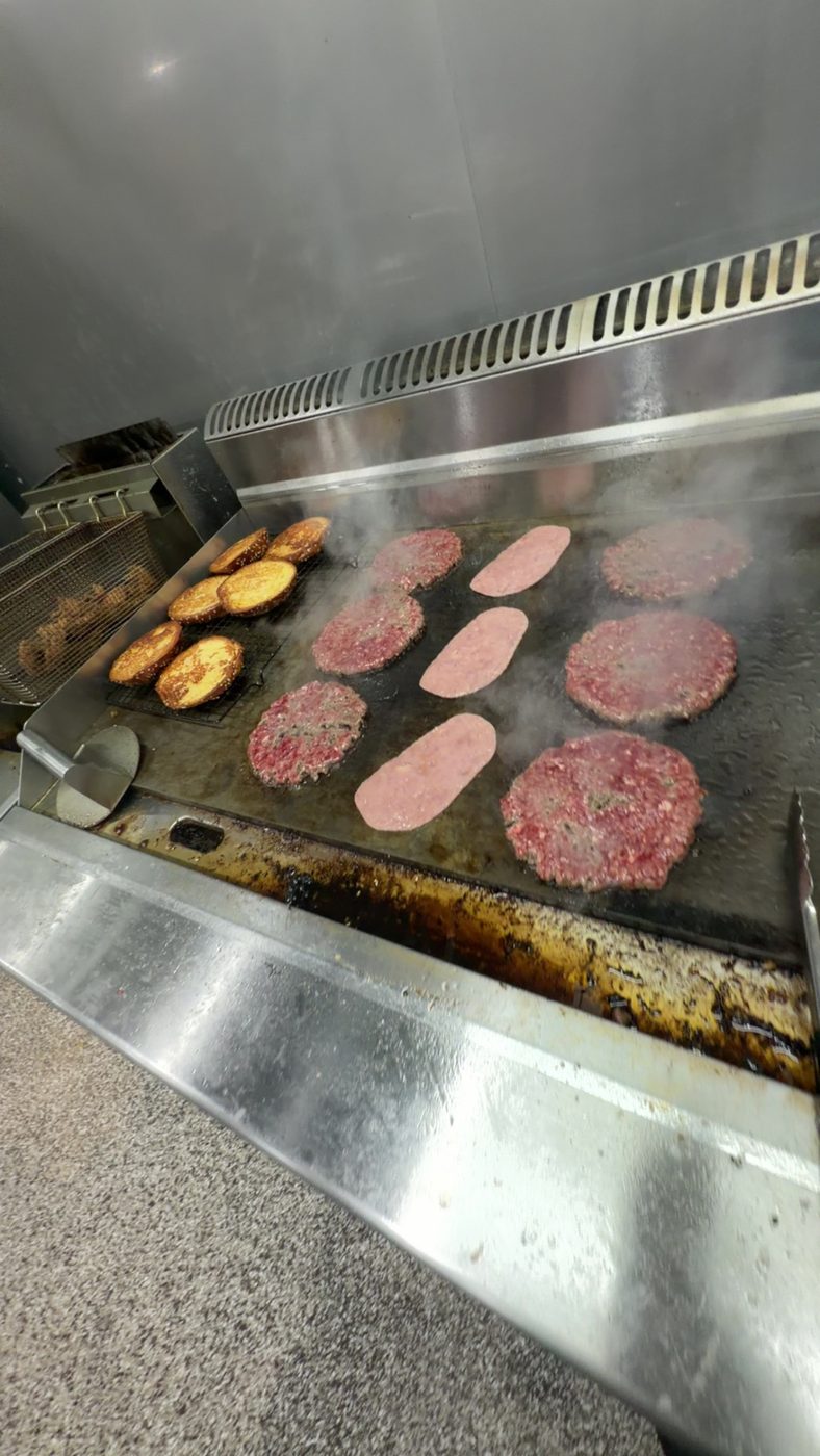 Burger patties cooking on the grill